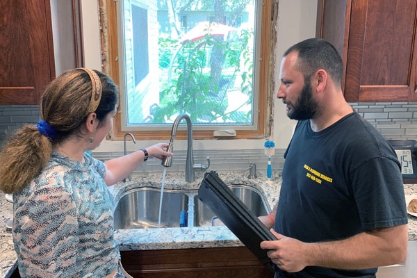 DPS plumber Mike working on a local sump pump installation